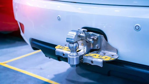 Vehicle back end showing installed trailer coupler and mounting plate.